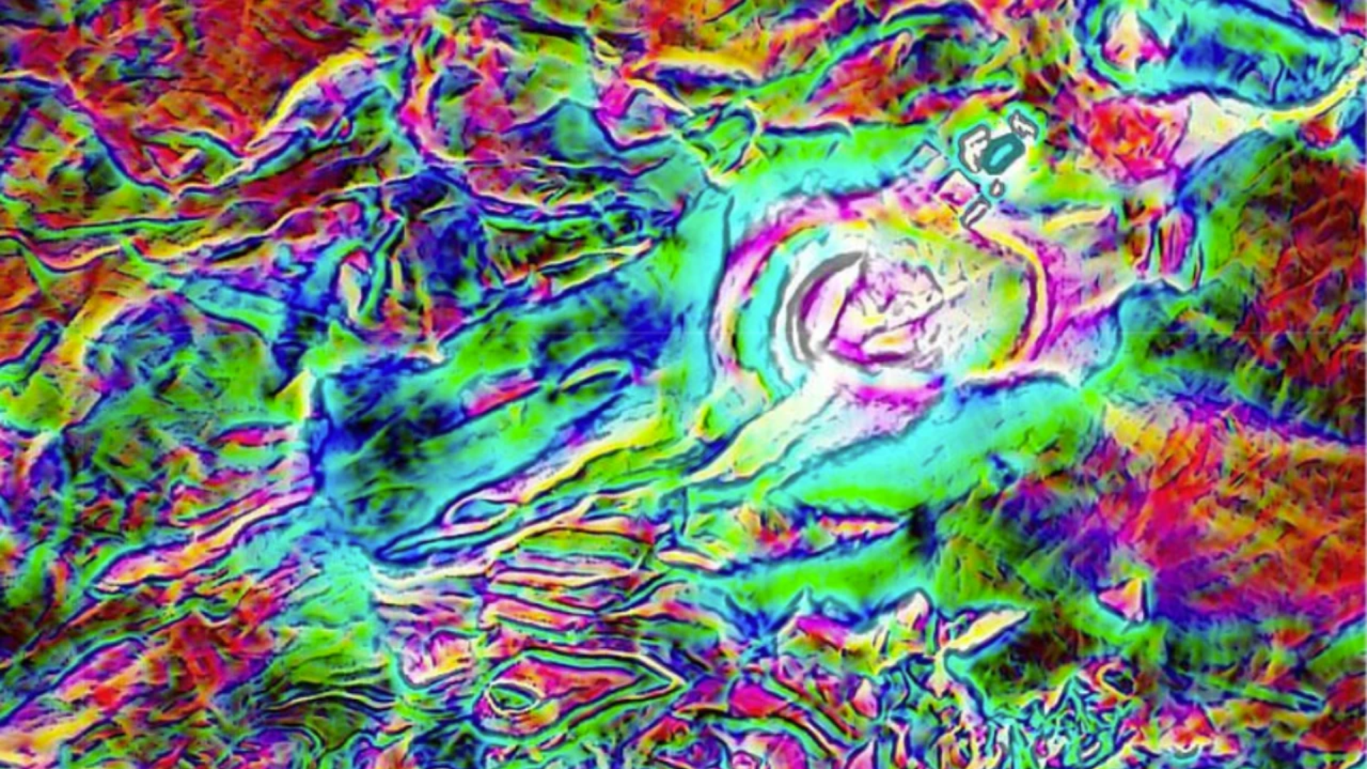 A vibrant, abstract satellite image shows a landscape in swirling colors of blue, green, red, and yellow, highlighting varied terrain elevations and geological features with a mix of smooth and jagged patterns.