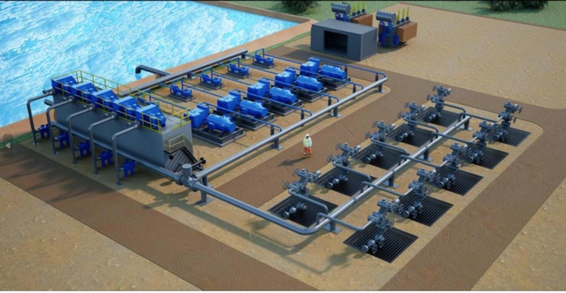 Aerial view of an industrial water treatment facility with blue machinery, large tanks, pipes, and a worker standing in the center, next to a body of water.