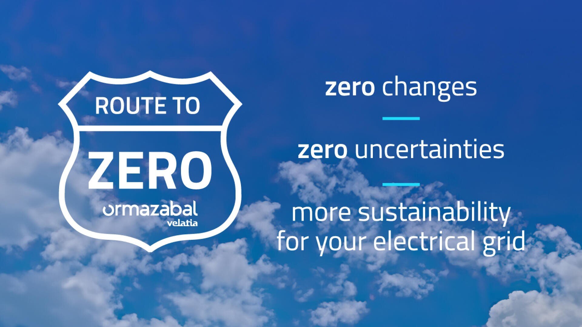 A blue sky with white clouds background features a road sign that reads Route to Zero Ormazabal Velatia. Text beside it says zero changes, zero uncertainties, more sustainability for your electrical grid.
