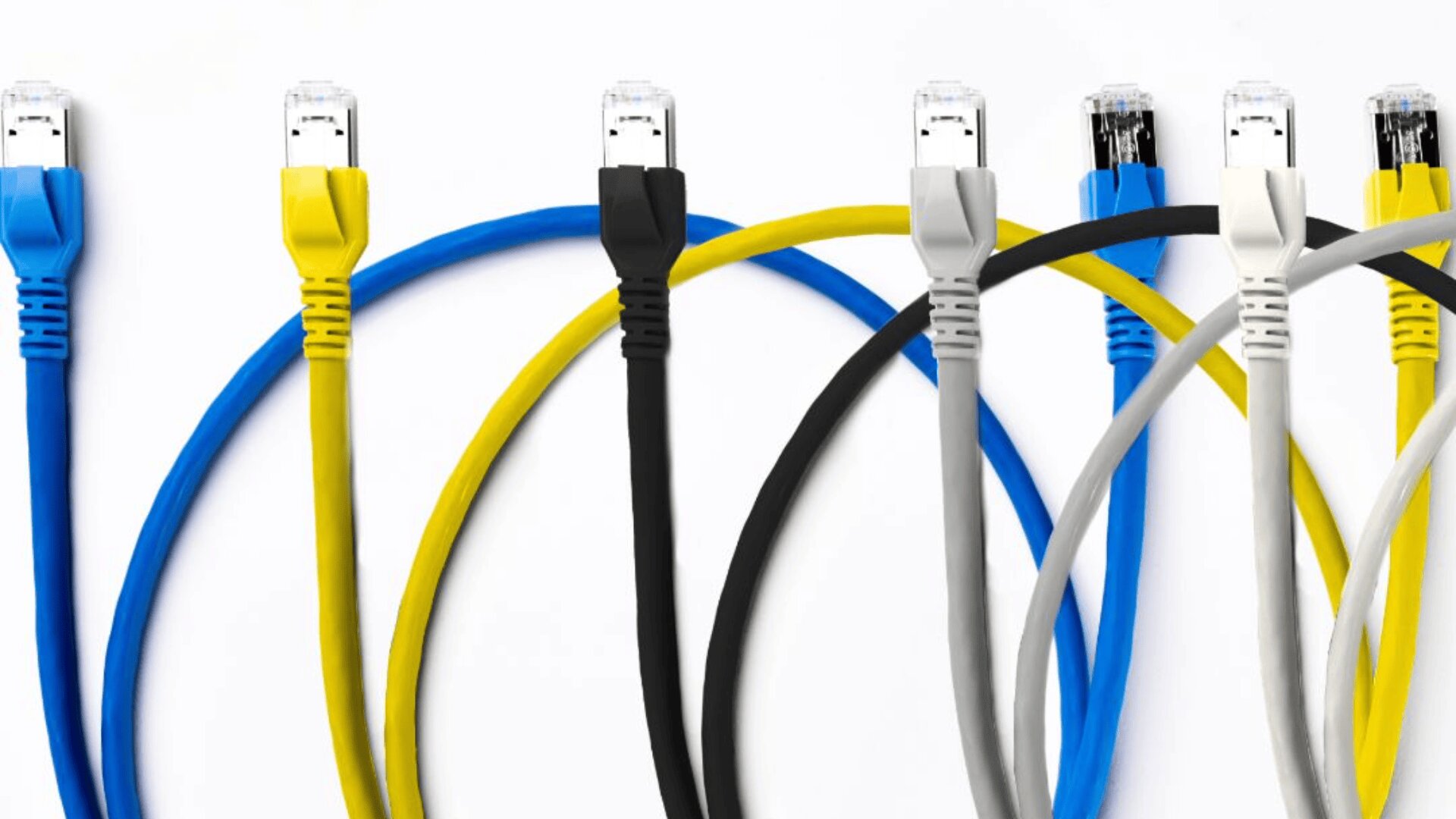 Fünf Ethernet-Kabel in den Farben Blau, Gelb, Schwarz, Grau und Weiß sind vertikal aufgereiht, wobei die Kabel vor einem weißen Hintergrund nach unten gebogen sind.
