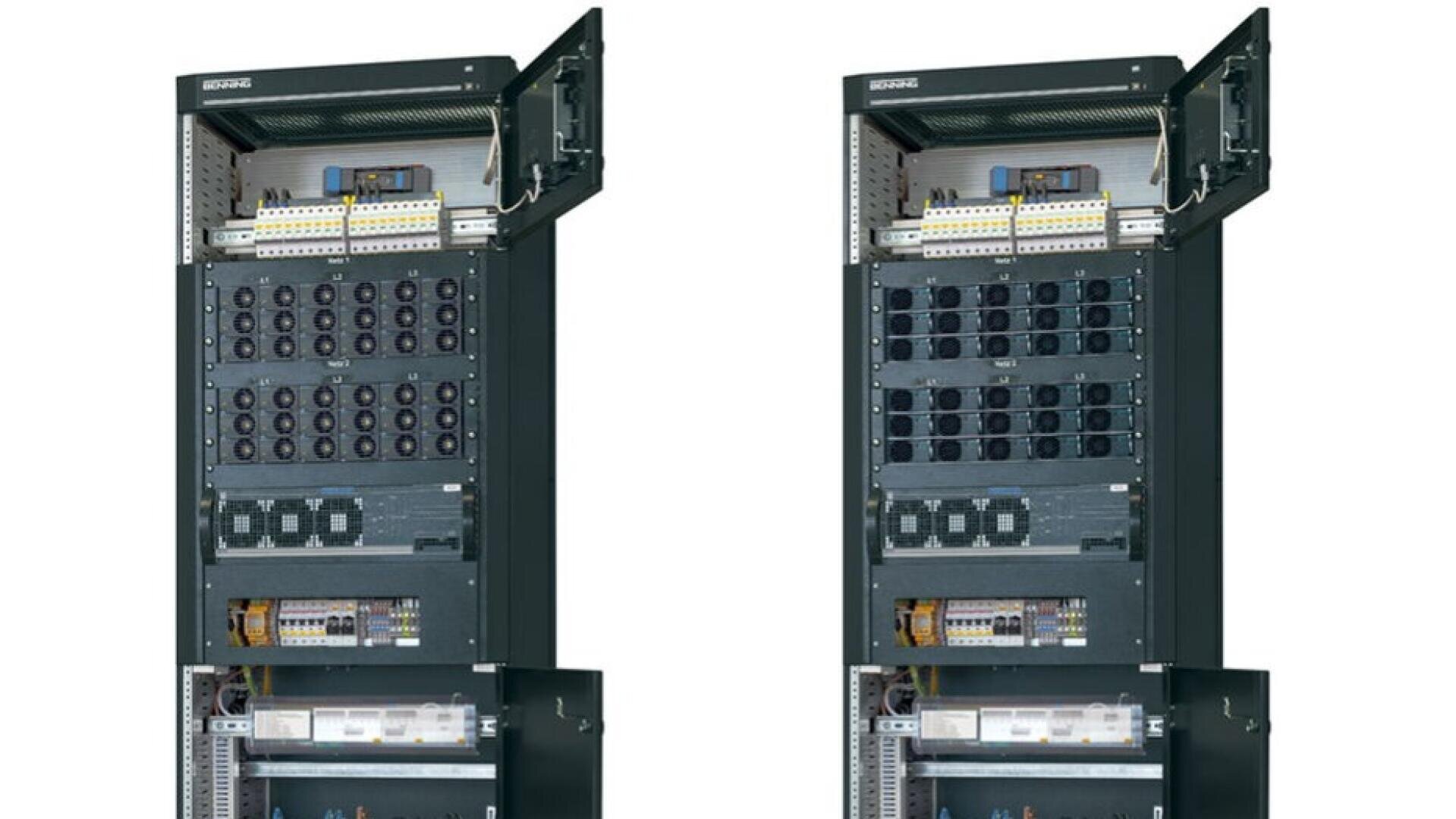 Two tall, black server racks with open top doors are positioned side by side. The racks contain multiple modules, cables, and components arranged in several rows and sections.