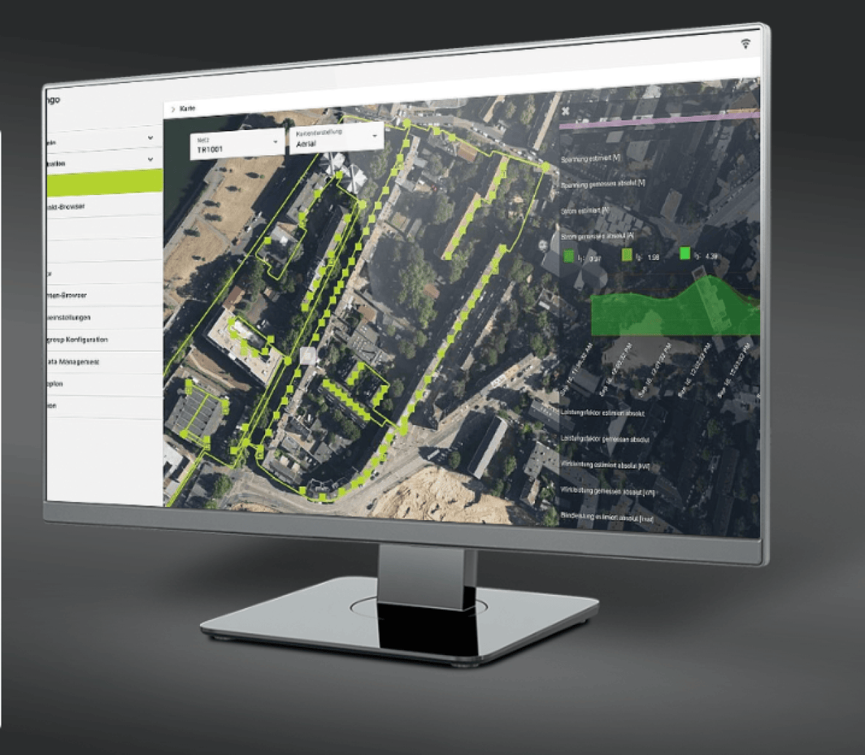 A computer monitor displays an aerial map with highlighted routes and buildings, featuring a sidebar menu and various data overlays, suggesting the use of mapping or surveying software.