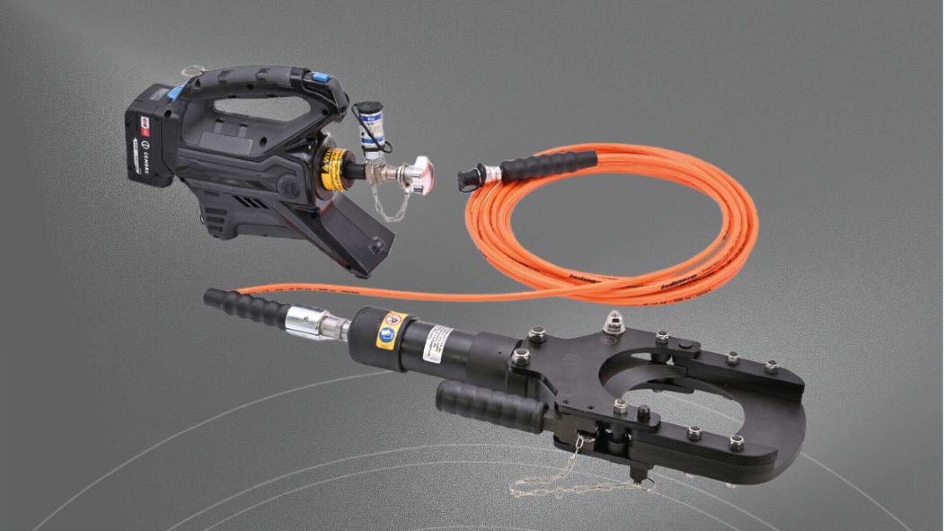 A portable hydraulic cutting device with a black motor connected by a long orange hose to a black high-performance cutting head with handles, shown on a gray background.