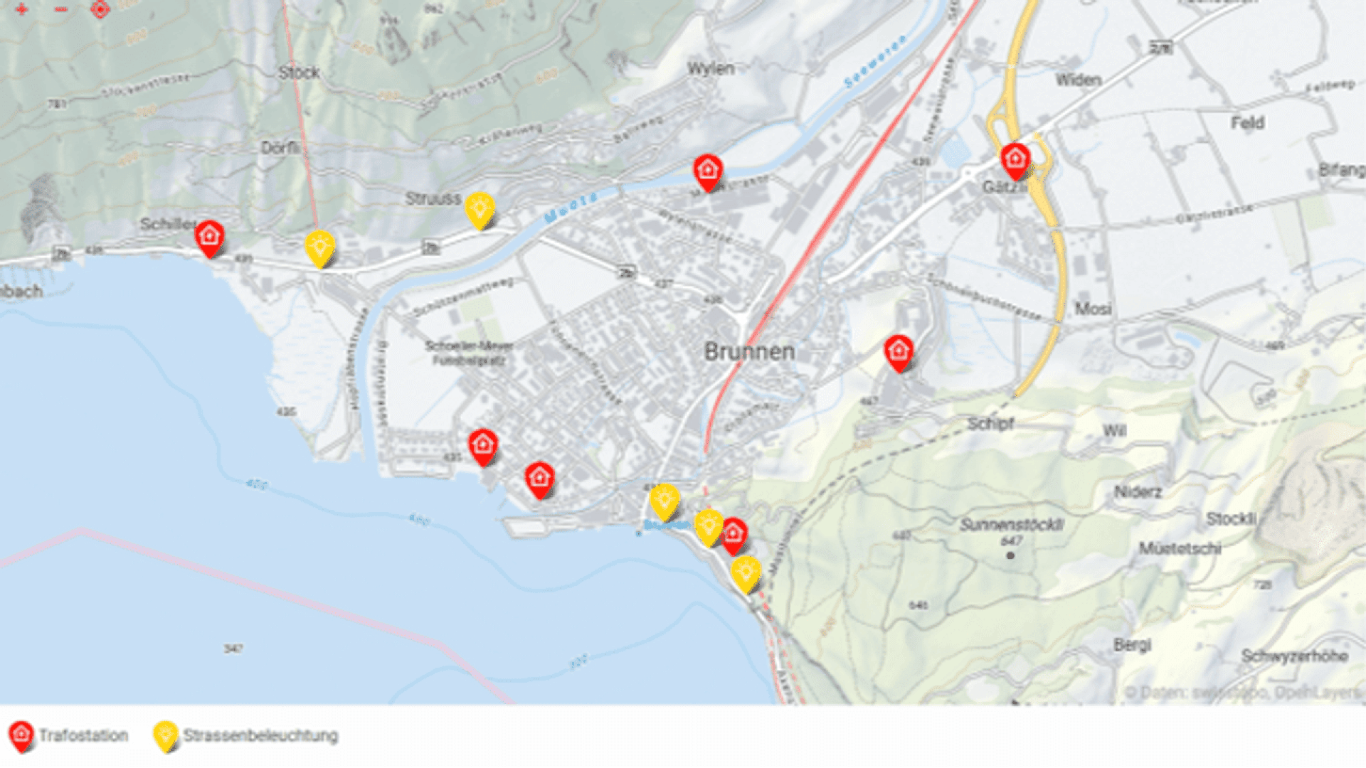 A map of Brunnen, Switzerland, shows locations of transformer stations (red icons) and street lighting (yellow icons) near the town center and waterfront, with marked roads and surrounding areas labeled.